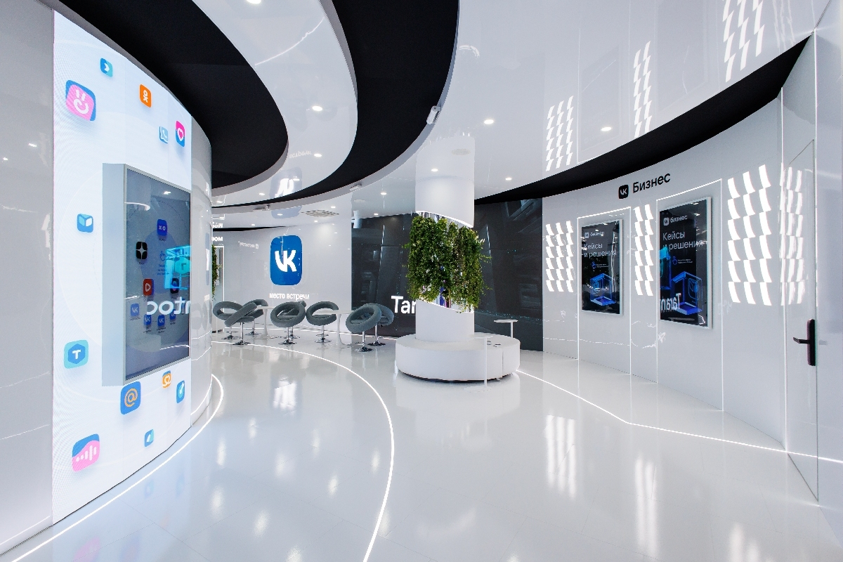 On the left, the “VK Ecosystem” touch screen in the wall with service icons; on the right, two “VK Business” panels with the “Cases and solutions” start screen